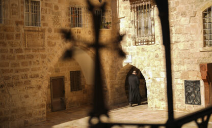 An Armenian Christian priest walks along an alley near to St. James Cathedral at the Armenian quarter in Jerusalem, Thursday, Nov. 21, 2024. (AP Photo/Francisco Seco)