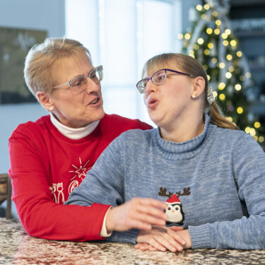 Kathleen Krueger and her daughter, Megan, 28, sit together at their home in Racine, Wis., Friday, Dec. 20, 2024. (AP Photo/Andy Manis)