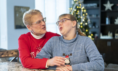 Kathleen Krueger and her daughter, Megan, 28, sit together at their home in Racine, Wis., Friday, Dec. 20, 2024. (AP Photo/Andy Manis)