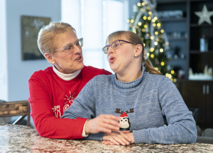 Kathleen Krueger and her daughter, Megan, 28, sit together at their home in Racine, Wis., Friday, Dec. 20, 2024. (AP Photo/Andy Manis)