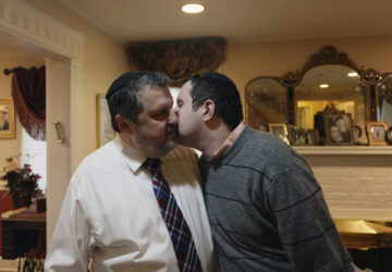 Dov Marcus, right, kisses his father, Robert Marcus, in Teaneck, N.J., on Friday, Dec. 20, 2024. (AP Photo/Luis Andres Henao)