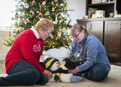 Kathleen Krueger plays with her daughter, Megan, 28, at their home in Racine, Wis., Friday, Dec. 20, 2024. (AP Photo/Andy Manis)