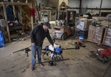 Russell Hedrick pulls out an EA Vision drone on his farm, Tuesday, Dec. 17, 2024, in Hickory, N.C. (AP Photo/Allison Joyce)