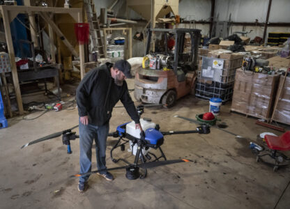 Russell Hedrick pulls out an EA Vision drone on his farm, Tuesday, Dec. 17, 2024, in Hickory, N.C. (AP Photo/Allison Joyce)