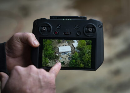 Russell Hedrick shows footage of when he used his drone to drop supplies to people during Hurricane Helene recovery, Tuesday, Dec. 17, 2024, in Hickory, N.C. (AP Photo/Allison Joyce)