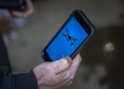 Russell Hedrick shows footage of when he used his drone to drop supplies to people during Hurricane Helene recovery, Tuesday, Dec. 17, 2024, in Hickory, N.C. (AP Photo/Allison Joyce)