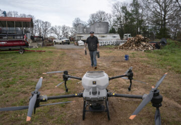 Russell Hedrick prepares a DJI drone to put crop cover on his farm, Tuesday, Dec. 17, 2024, in Hickory, N.C. (AP Photo/Allison Joyce)