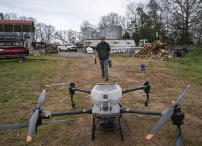 Russell Hedrick prepares a DJI drone to put crop cover on his farm, Tuesday, Dec. 17, 2024, in Hickory, N.C. (AP Photo/Allison Joyce)