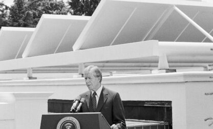 FILE - President Jimmy Carter speaks against a backdrop of solar panels at the White House, June 21, 1979, in Washington. (AP Photo/Harvey Georges, File)