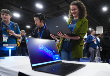 Rebecca Isaacs checks out the new LG gram 2-in-1 convertible laptop offering the versatility of both a laptop and tablet during 2025 CES Unveiled, Sunday, Jan. 5, 2025, in Las Vegas. (AP Photo/Jack Dempsey)