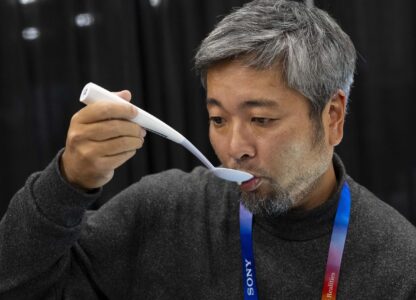 Kiyohiro Izumo uses the Kirin Electric Salt spoon which intensifies salt flavor by flowing a mild electric current through the food around the tongue to attract salt towards the tongue, during 2025 CES Unveiled, Sunday, Jan. 5, 2025, in Las Vegas. (AP Photo/Jack Dempsey)