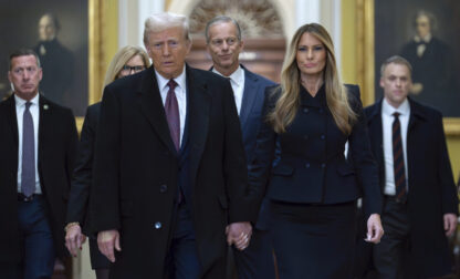 President-elect Donald Trump walks with Melania Trump at the Capitol, Wednesday, Jan. 8, 2025, in Washington, followed by Senate Majority Leader John Thune, R-S.D. (AP Photo/Jose Luis Magana)