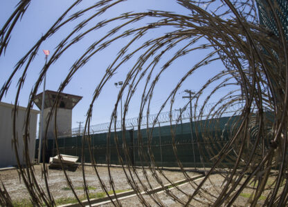 FILE - In this April 17, 2019, photo, reviewed by U.S. military officials, the control tower is seen through the razor wire inside the Camp VI detention facility in Guantanamo Bay Naval Base, Cuba. (AP Photo/Alex Brandon, File)