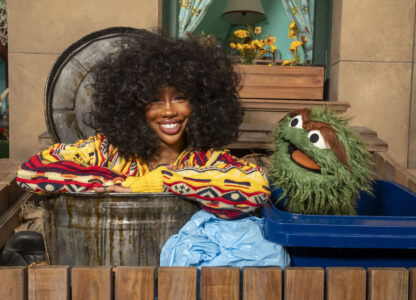 This image released by Sesame Workshop shows singer SZA, left, with muppet character Oscar the Grouch on the set of 