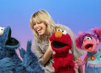 This image released by Sesame Workshop shows actor-singer Renee Rapp with muppet characters Cookie Monster, from left, Elmo and Abby Cadabby on the set of 