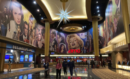 FILE - People walk in an AMC Theater in Paramus, New Jersey, on Monday, March 13, 2023. (AP Photo/Ted Shaffrey, File)