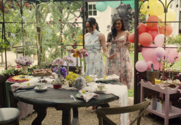 This image released by Netflix shows Meghan, Duchess of Sussex, and Mindy Kaling in a scene from her series 