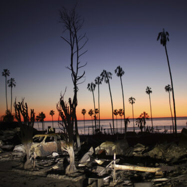 The devastation of the Palisades Fire is seen at sunset in the Pacific Palisades neighborhood of Los Angeles, Tuesday, Jan. 14, 2025. (AP Photo/Ethan Swope)