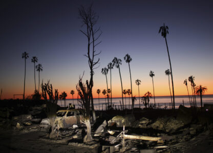 The devastation of the Palisades Fire is seen at sunset in the Pacific Palisades neighborhood of Los Angeles, Tuesday, Jan. 14, 2025. (AP Photo/Ethan Swope)