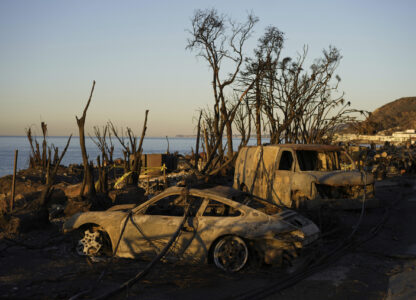 Charred vehicles sit along the Pacific Coast Highway, Tuesday, Jan. 14, 2025, in Malibu, Calif. (AP Photo/Carolyn Kaster)