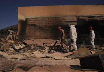 Search and rescue workers dig through the rubble left behind by the Eaton Fire, in Altadena, Calif., Tuesday, Jan. 14, 2025. (AP Photo/Jae C. Hong)