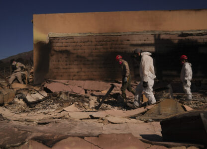 Search and rescue workers dig through the rubble left behind by the Eaton Fire, in Altadena, Calif., Tuesday, Jan. 14, 2025. (AP Photo/Jae C. Hong)