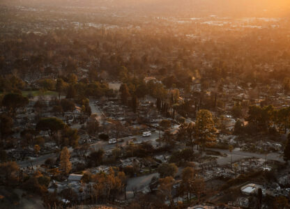 Trucks drive through a neighborhood destroyed by the Eaton Fire, Tuesday, Jan. 14, 2025, in Altadena, Calif. (AP Photo/John Locher)