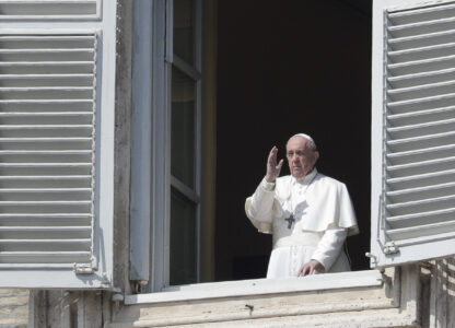 FILE - Pope Francis delivers his blessing from the window of his private library overlooking St. Peter's Square, at the Vatican, March 22, 2020. (AP Photo/Andrew Medichini, File)