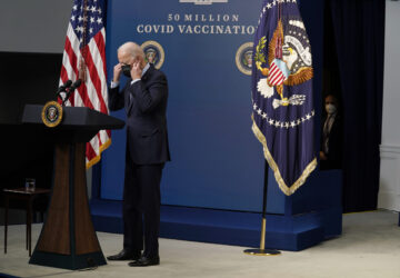 FILE - President Joe Biden puts on his face mask after speaking during an event to commemorate the 50 millionth COVID-19 shot, in the South Court Auditorium on the White House campus, Feb. 25, 2021, in Washington. (AP Photo/Evan Vucci, File)