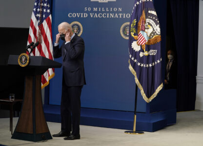 FILE - President Joe Biden puts on his face mask after speaking during an event to commemorate the 50 millionth COVID-19 shot, in the South Court Auditorium on the White House campus, Feb. 25, 2021, in Washington. (AP Photo/Evan Vucci, File)