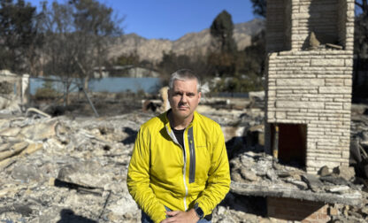 Ryan Pearson, a Los Angeles-based entertainment video editor for The Associated Press, sits in front of his home that was destroyed by the Eaton Fire, Wednesday, Jan. 15, 2025, in Altadena, Calif. (AP Photo/Ryan Pearson)