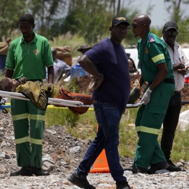 A miner is transported on a stretcher by rescue workers after he was rescued from below ground in an abandoned gold mine in Stilfontein, South Africa, Tuesday, Jan. 14, 2025. (AP Photo/Themba Hadebe)