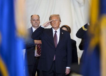 President Donald Trump salutes while on stage in Emancipation Hall at the 60th Presidential Inauguration, Monday, Jan. 20, 2025, at the U.S. Capitol in Washington. (Al Drago/Pool Photo via AP)