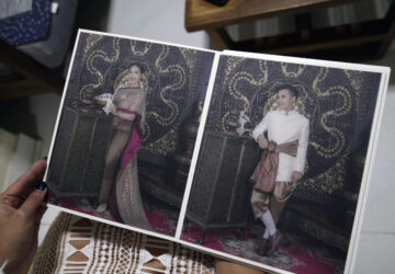 Sunma Piamboon displays the wedding photographs with Danaya Phonphayung in Bangkok, Thailand, on Jan. 13, 2025. (AP Photo/Sakchai Lalit)