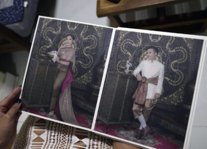 Sunma Piamboon displays the wedding photographs with Danaya Phonphayung in Bangkok, Thailand, on Jan. 13, 2025. (AP Photo/Sakchai Lalit)