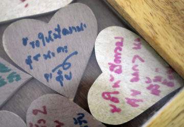 Pieces of heart-shaped wood with messages from friends of Sunma Piamboon and Danaya Phonphayung are kept in a wooden frame in Bangkok, Thailand, on Jan. 13, 2025. The words read 