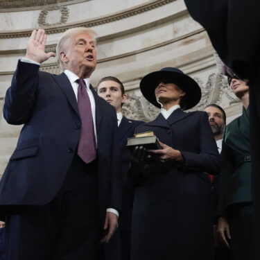 Donald Trump is sworn in as the 47th president of the United States by Chief Justice John Roberts as Melania Trump holds the Bible during the 60th Presidential Inauguration in the Rotunda of the U.S. Capitol in Washington, Monday, Jan. 20, 2025. (AP Photo/Morry Gash, Pool)