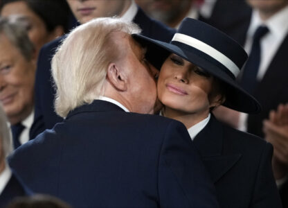 President Donald Trump kisses first lady Melania Trump during the 60th Presidential Inauguration in the Rotunda of the U.S. Capitol in Washington, Monday, Jan. 20, 2025. (AP Photo/Julia Demaree Nikhinson, Pool)