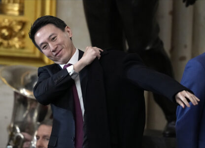 CORRECTS ID TO TIKTOK CEO - TikTok CEO Shou Chew puts on his coat after the 60th Presidential Inauguration in the Rotunda of the U.S. Capitol in Washington, Monday, Jan. 20, 2025. (AP Photo/Julia Demaree Nikhinson, Pool)