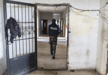 A member of the new Syrian security forces walks into a military headquarters that belonged to the Assad government, in Nawa, near Daraa, Syria, Jan. 4, 2025. (AP Photo/Mosa'ab Elshamy)