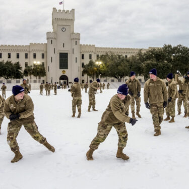 Citadel cadets engage in a snowball fight during a very rare snow day to their campus on Wednesday Jan. 22, 2025 in Charleston, S.C. (Ed Wray/The Citadel via AP)