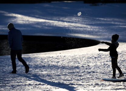 A child throws a snowball at his father in Hampton Park after a winter storm dropped ice and snow Wednesday, Jan. 22, 2025, in Charleston, S.C. (AP Photo/Mic Smith)