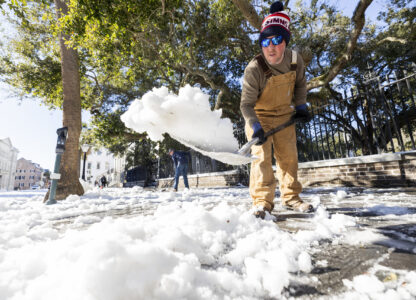 Dylan Gilbert, with the City of Charleston, removes snow in front of City Hall after a winter storm dropped ice and snow Wednesday, Jan. 22, 2025, on Charleston, S.C. (AP Photo/Mic Smith)