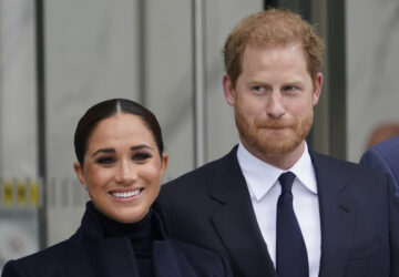 FILE - Meghan Markle and Prince Harry pose for pictures after visiting the observatory in One World Trade in New York, Sept. 23, 2021.(AP Photo/Seth Wenig, File)