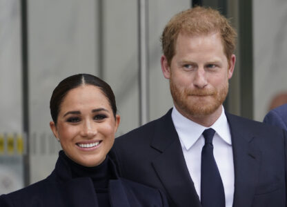 FILE - Meghan Markle and Prince Harry pose for pictures after visiting the observatory in One World Trade in New York, Sept. 23, 2021.(AP Photo/Seth Wenig, File)