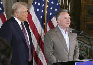 FILE - President-elect Donald Trump listens to Steve Witkoff speak during a news conference at Mar-a-Lago, Jan. 7, 2025, in Palm Beach, Fla. (AP Photo/Evan Vucci, File)