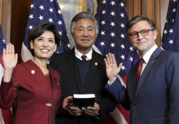 House Speaker Mike Johnson, R-La., right, poses during a ceremonial swearing-in with Rep. Young Kim, R-Calif., left, in the Rayburn Room at the Capitol in Washington, Friday, Jan. 3, 2025. (AP Photo/Jacquelyn Martin)