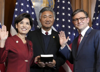 House Speaker Mike Johnson, R-La., right, poses during a ceremonial swearing-in with Rep. Young Kim, R-Calif., left, in the Rayburn Room at the Capitol in Washington, Friday, Jan. 3, 2025. (AP Photo/Jacquelyn Martin)