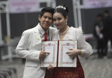 CORRECTS THE NAME OF THE PERSON AT RIGHT - Kwanporn Kongpetch, left, and Ploynaplus Chirasukon from the LGBTQ+ community show their marriage certificates after the Marriage Equality Act took effect in Bangkok, Thailand, Thursday, Jan. 23, 2025. (AP Photo/Sakchai Lalit)