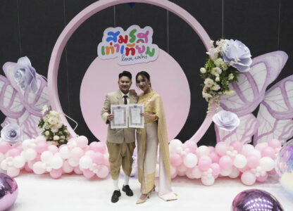 A couple from the LGBTQ+ community shows their marriage certificate in Bangkok, Thailand, Thursday, Jan. 23, 2025. (AP Photo/Sakchai Lalit)